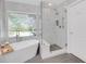 Bathroom features a large walk-in shower and a free-standing soaking tub at 336 Del Sol Ave, Davenport, FL 33837