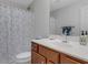 Clean bathroom with shower, single sink vanity, and wood cabinets at 336 Del Sol Ave, Davenport, FL 33837