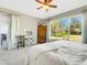 Bedroom with large window, plush bed, and wood accents at 336 Del Sol Ave, Davenport, FL 33837