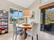 Bright dining room with round wooden table and view to backyard at 336 Del Sol Ave, Davenport, FL 33837