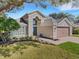 Two-story house with landscaping and a brick walkway at 336 Del Sol Ave, Davenport, FL 33837