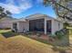 Single-story house with a screened porch and well-maintained lawn at 336 Del Sol Ave, Davenport, FL 33837