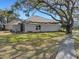 Single-story house with a screened porch, side yard, and walkway at 336 Del Sol Ave, Davenport, FL 33837
