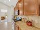 Kitchen with granite countertops, stainless steel appliances, and wood cabinets at 336 Del Sol Ave, Davenport, FL 33837