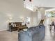 Open concept living room with two sofas, high ceilings, and natural light at 336 Del Sol Ave, Davenport, FL 33837