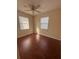 Well-lit bedroom featuring wood-look floors and neutral walls at 520 Carlsbad Dr, Kissimmee, FL 34758