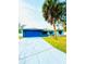 Ranch-style home with blue garage door and palm tree at 520 Carlsbad Dr, Kissimmee, FL 34758