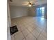 Spacious living room with tile floors and sliding glass doors leading to a patio at 520 Carlsbad Dr, Kissimmee, FL 34758