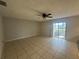 Spacious living room with tile floors and sliding glass doors leading to a patio at 520 Carlsbad Dr, Kissimmee, FL 34758