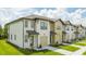 Townhome community featuring multiple two-story units with attached garages at 607 Longboat Dr, Davenport, FL 33896