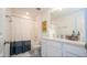 Bathroom with tub shower combo and white vanity at 607 Longboat Dr, Davenport, FL 33896