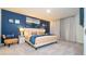 Spacious bedroom featuring a king-size bed and blue accent wall at 607 Longboat Dr, Davenport, FL 33896