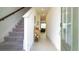 Bright entryway with gray carpeting stairs and tile flooring at 607 Longboat Dr, Davenport, FL 33896