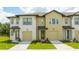 Two-story townhome with neutral siding, attached garage, and landscaping at 607 Longboat Dr, Davenport, FL 33896