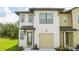 Two-story townhome with neutral siding, attached garage, and front door at 607 Longboat Dr, Davenport, FL 33896