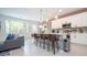 Open kitchen with island seating, white cabinetry, and modern lighting at 607 Longboat Dr, Davenport, FL 33896