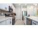 Modern white kitchen with stainless steel appliances and tile backsplash at 607 Longboat Dr, Davenport, FL 33896