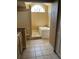 Well-lit bathroom with a tub under an arched window, and a separate shower area at 615 Gazelle Dr, Kissimmee, FL 34759