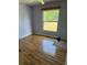 Bedroom with wood floors and large window overlooking backyard at 615 Gazelle Dr, Kissimmee, FL 34759