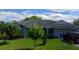 One-story house with gray siding, a large yard, and a driveway at 615 Gazelle Dr, Kissimmee, FL 34759