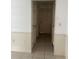 Hallway with neutral walls, wainscotting and view of doorways at 615 Gazelle Dr, Kissimmee, FL 34759