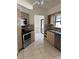 Kitchen featuring stainless steel appliances and cabinetry with dark countertops at 615 Gazelle Dr, Kissimmee, FL 34759