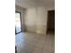 Bright living room with neutral walls, white wainscotting and sliding door access to backyard at 615 Gazelle Dr, Kissimmee, FL 34759