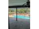Enclosed pool area featuring an in-ground pool surrounded by a patio and screened enclosure at 615 Gazelle Dr, Kissimmee, FL 34759