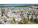 Aerial view of a community with a pond and lush greenery in the background at 6826 Goldflower Ave, Harmony, FL 34773