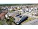 Aerial view of a neighborhood with a house featuring solar panels at 6826 Goldflower Ave, Harmony, FL 34773