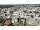 Aerial view of neighborhood with houses and lake at 6826 Goldflower Ave, Harmony, FL 34773