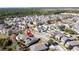 Aerial view of a house with solar panels and a lush green lawn at 6826 Goldflower Ave, Harmony, FL 34773