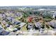 Aerial view of property near lush greenery, water features, and a golf course at 6826 Goldflower Ave, Harmony, FL 34773