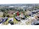 Aerial view of a house with a pond and greenery in the background at 6826 Goldflower Ave, Harmony, FL 34773