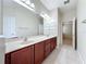 Bright bathroom with double vanity, tile floor, and neutral paint at 6826 Goldflower Ave, Harmony, FL 34773