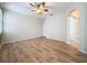 Bedroom featuring wood floors, a ceiling fan and a bright window at 6826 Goldflower Ave, Harmony, FL 34773