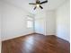 Bright bedroom with wood floors, a ceiling fan, and a large closet for storage at 6826 Goldflower Ave, Harmony, FL 34773
