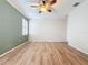 Large bedroom with wood flooring and a ceiling fan at 6826 Goldflower Ave, Harmony, FL 34773