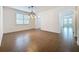 The dining room features stylish tiled flooring, neutral walls, arched doorways, and an elegant light fixture at 6826 Goldflower Ave, Harmony, FL 34773
