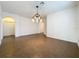 This dining room has tile floors, neutral colored walls, with an elegant light fixture, and arched doorways at 6826 Goldflower Ave, Harmony, FL 34773
