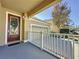 Charming front porch with a decorative door, wreath, and well-manicured landscaping at 6826 Goldflower Ave, Harmony, FL 34773