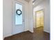 Bright hallway with a decorative glass front door, ceramic tile flooring, and a view into the first floor bathroom at 6826 Goldflower Ave, Harmony, FL 34773