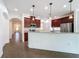 Kitchen featuring modern appliances, granite countertops, pendant lighting, and tile flooring at 6826 Goldflower Ave, Harmony, FL 34773