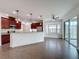 Open kitchen featuring stainless appliances, granite countertops, tiled floors and large sliding glass doors at 6826 Goldflower Ave, Harmony, FL 34773