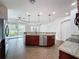 Open concept kitchen with stainless steel appliances and island seating at 6826 Goldflower Ave, Harmony, FL 34773