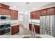 Beautiful kitchen features stainless steel appliances and granite countertops with wood cabinets at 6826 Goldflower Ave, Harmony, FL 34773