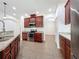 Bright kitchen with stainless steel appliances, granite counters, and tile flooring at 6826 Goldflower Ave, Harmony, FL 34773