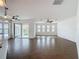 Open-concept living room with tile floors, multiple windows, and sliding glass doors leading to the patio at 6826 Goldflower Ave, Harmony, FL 34773