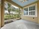 Inviting patio with a view of the lush, tropical landscaping and well-maintained backyard at 6826 Goldflower Ave, Harmony, FL 34773