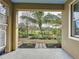 Inviting patio with a view of the lush, tropical landscaping and well-maintained backyard at 6826 Goldflower Ave, Harmony, FL 34773